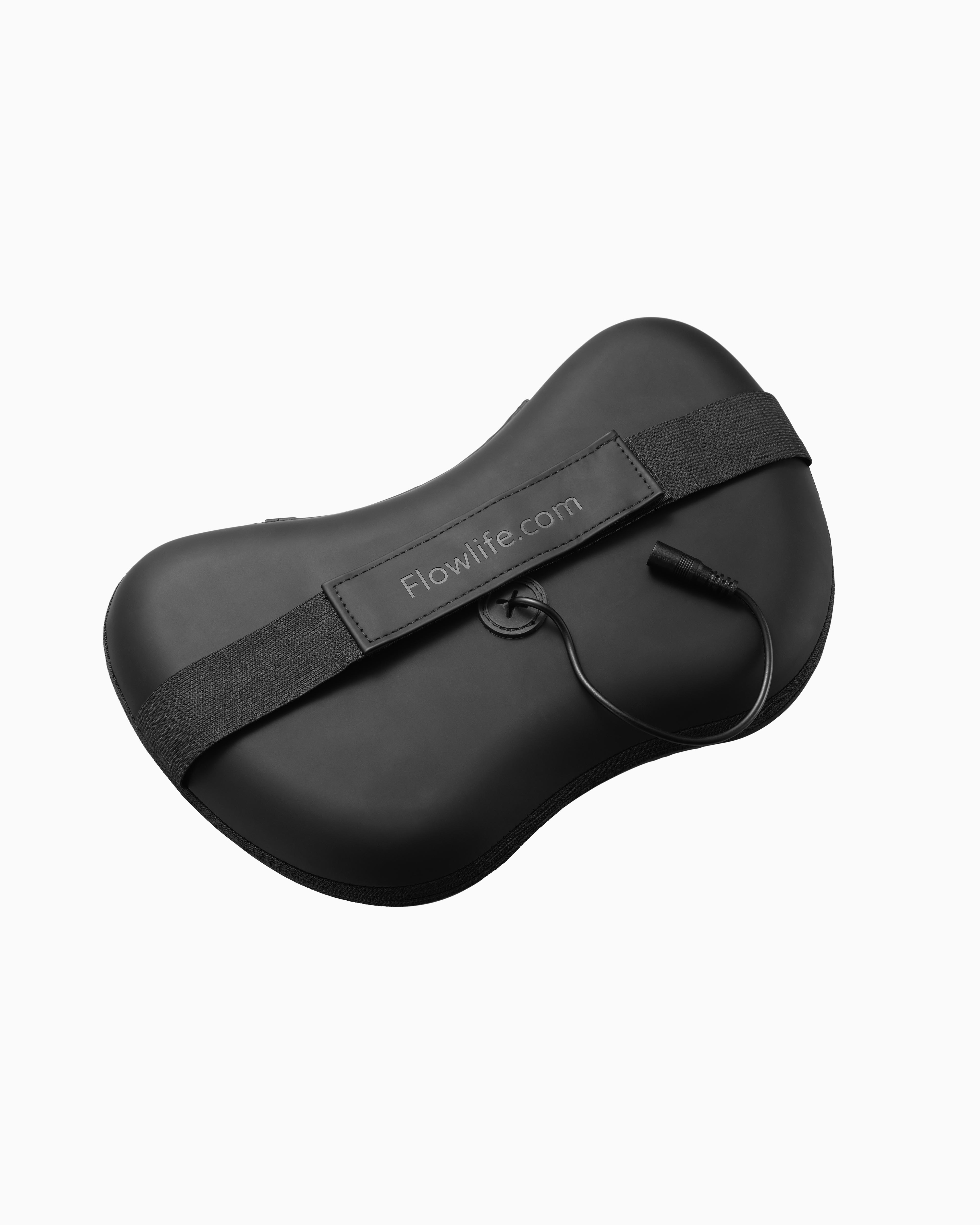 Back view of the black Flowpillow Heat massage pillow, showing the adjustable strap and the port for the charging cable.