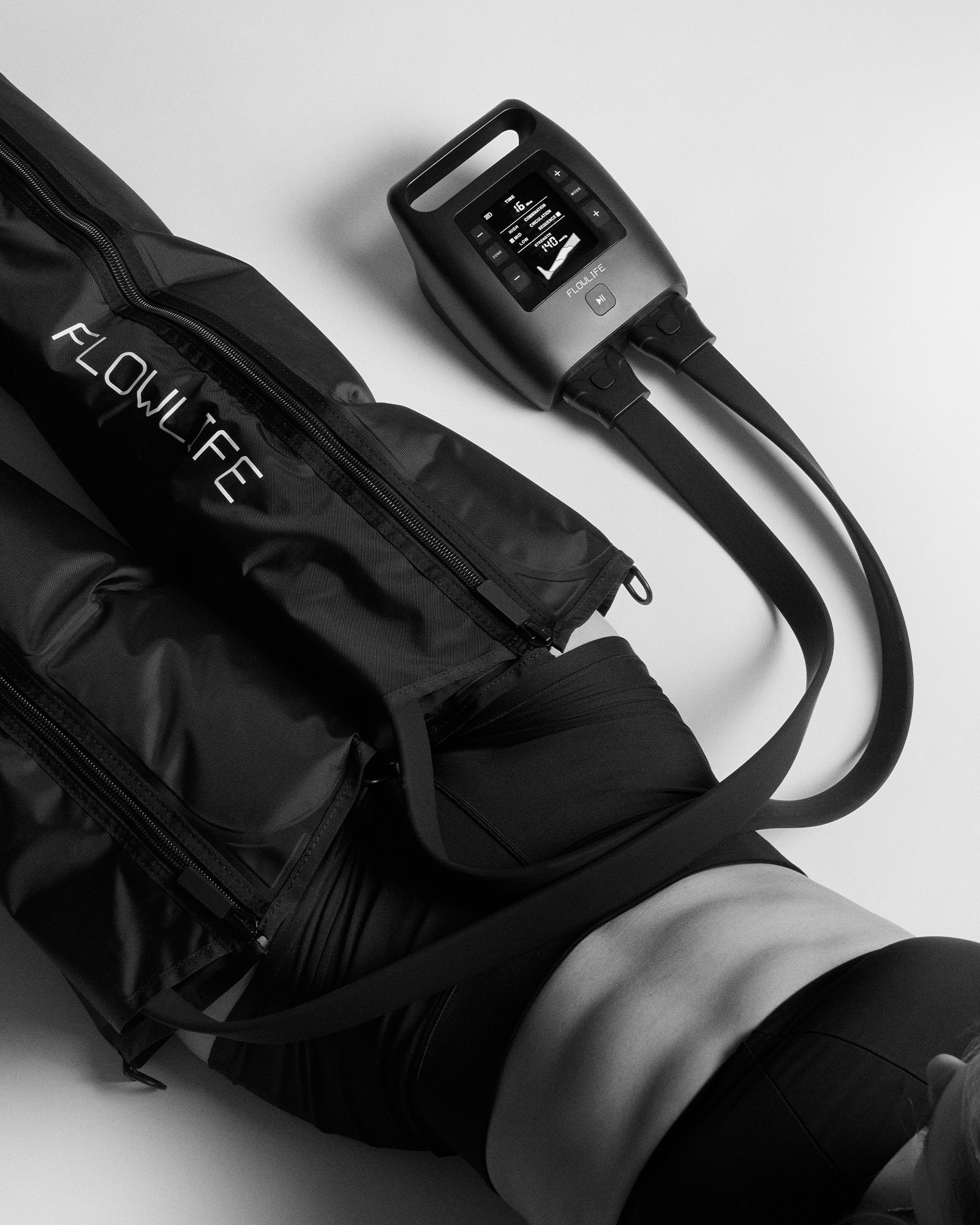 Black Flowpression Boots Pro+ with a digital control unit, providing sequential compression for professional leg recovery.