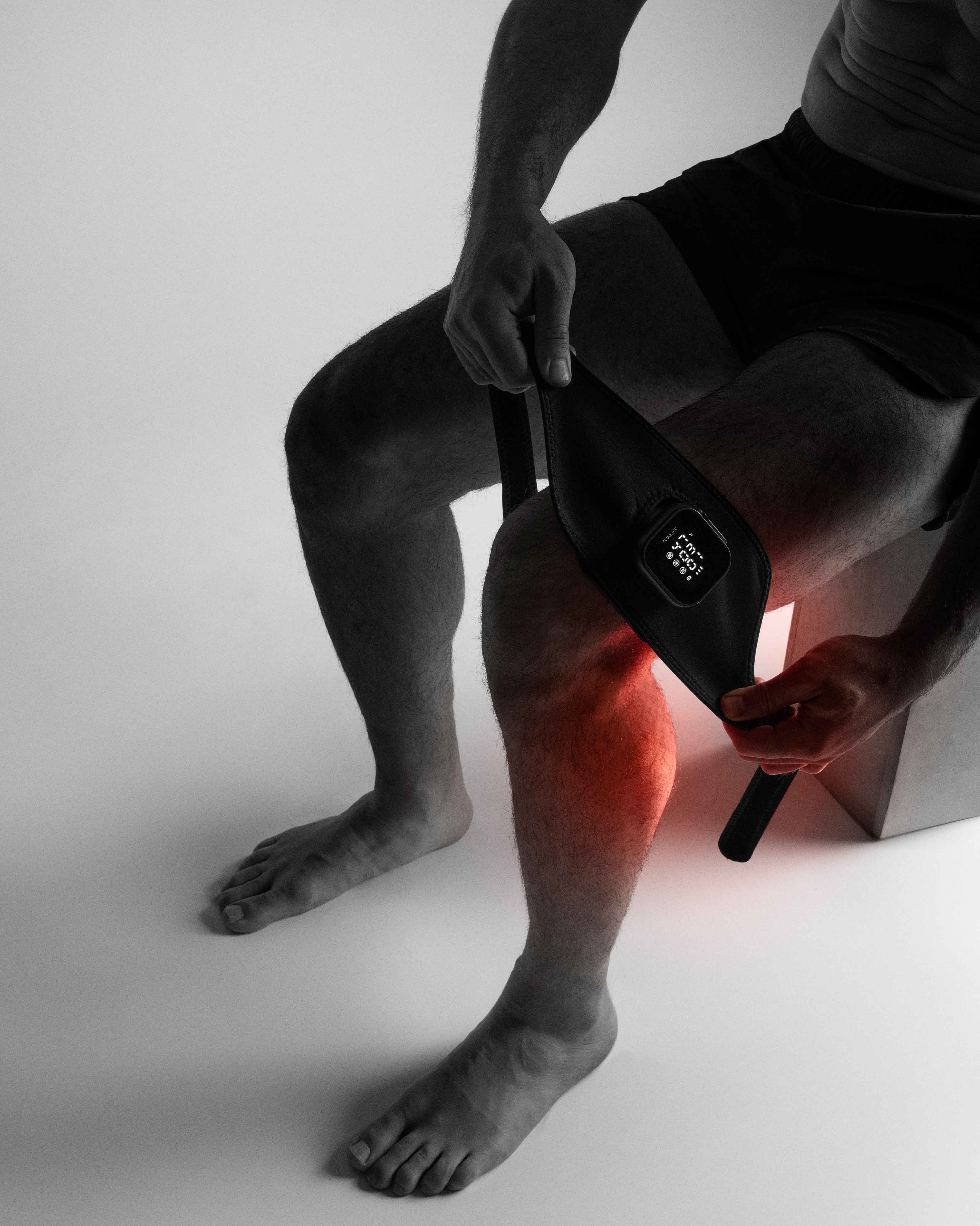 Flowtherma Spot applied to the Achilles tendon, providing targeted red-light and thermal therapy for recovery.