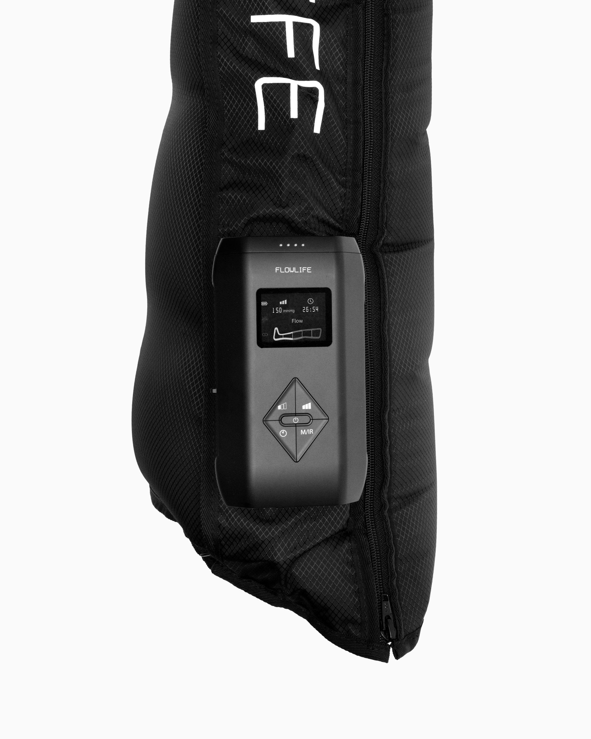 Close-up of the Flowpression Boots Ultra Red Light control unit with its display and buttons, mounted on the black quilted boot.