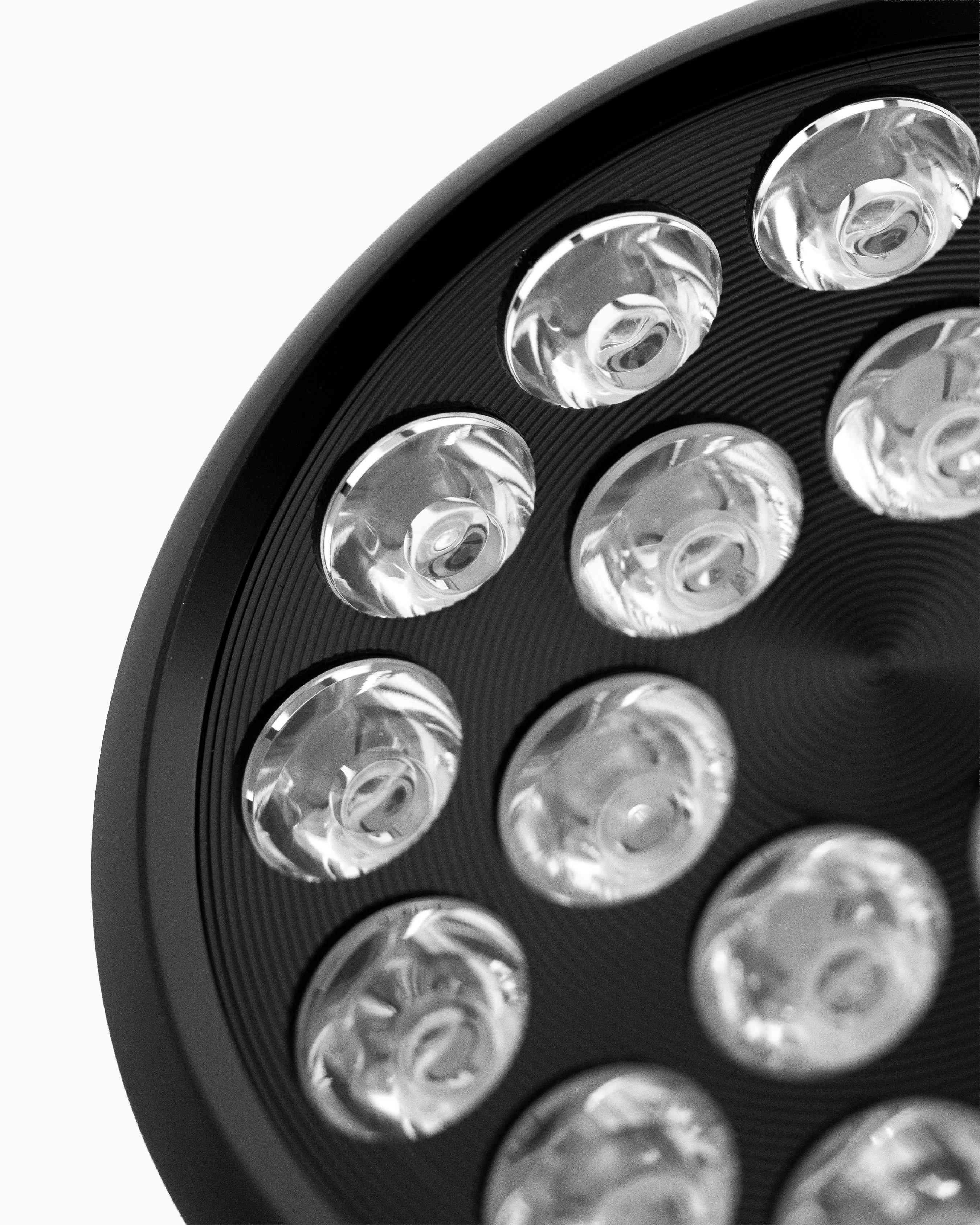 Close-up of Flowlight Bulb 50 Six Waves showing circular emitters in a textured black housing for recovery.